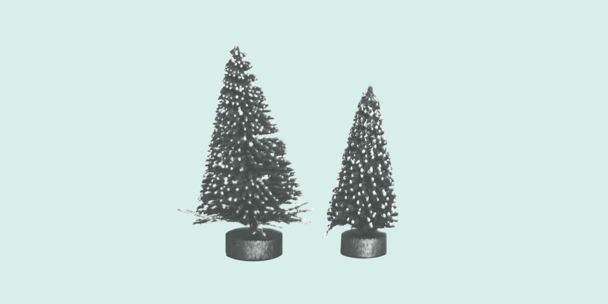 Tiny decorative pine trees on a light green background. Holiday Stress.