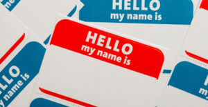 Blank adhesive name tags in red and blue, with the words "Hello my name is" printed on them.