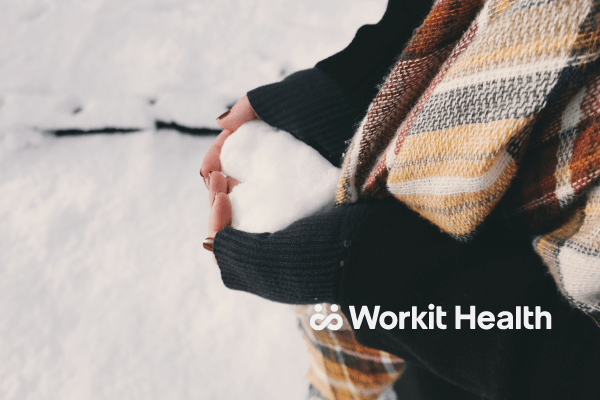 Woman holds snow in the shape of a heart. An alcoholic before 21