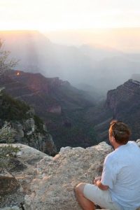 Kip Shubert, founder of Warriors on Purpose, sits on a mountain looking at the sunrise