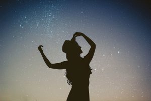 A dancing woman silhouetted by the stars. Life lessons in addiction recovery