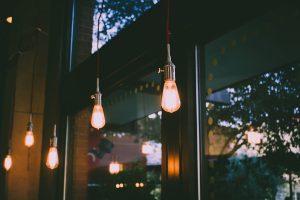 Trendy Edison bulbs hang in a restaurant.