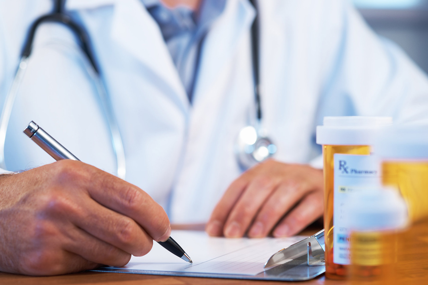 A doctor writes a prescription. Buprenorphine saves lives.