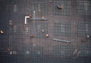 Aerial shot of construction workers laying rebar in a grid