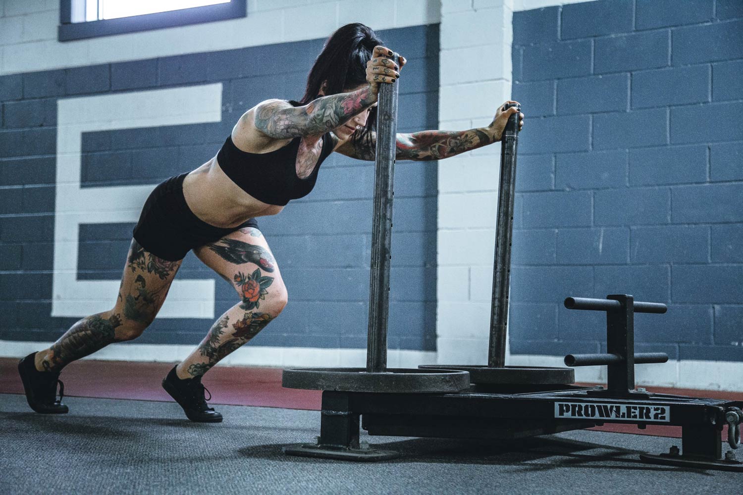 woman-pushing-weighted-sled