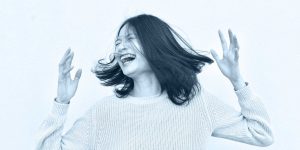 A laughing woman with her hands in the air