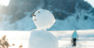 Happy snowman with its head tilted up as thoough enjoying the sun.