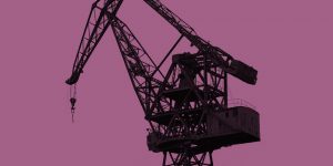 Grayscale photo of a construction crane against a magenta background