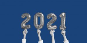 Hands holding up balloon numbers that say "2021". Celebrate New Years sober
