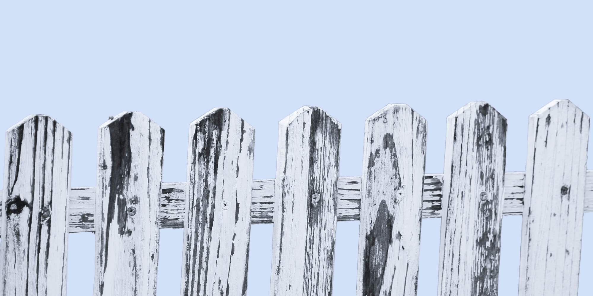 Wooden picket fence against a pale blue background. Boundaries are a gift