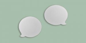Two paper speech bubbles on a pale green background. Interview with Dr. Kevin Armington