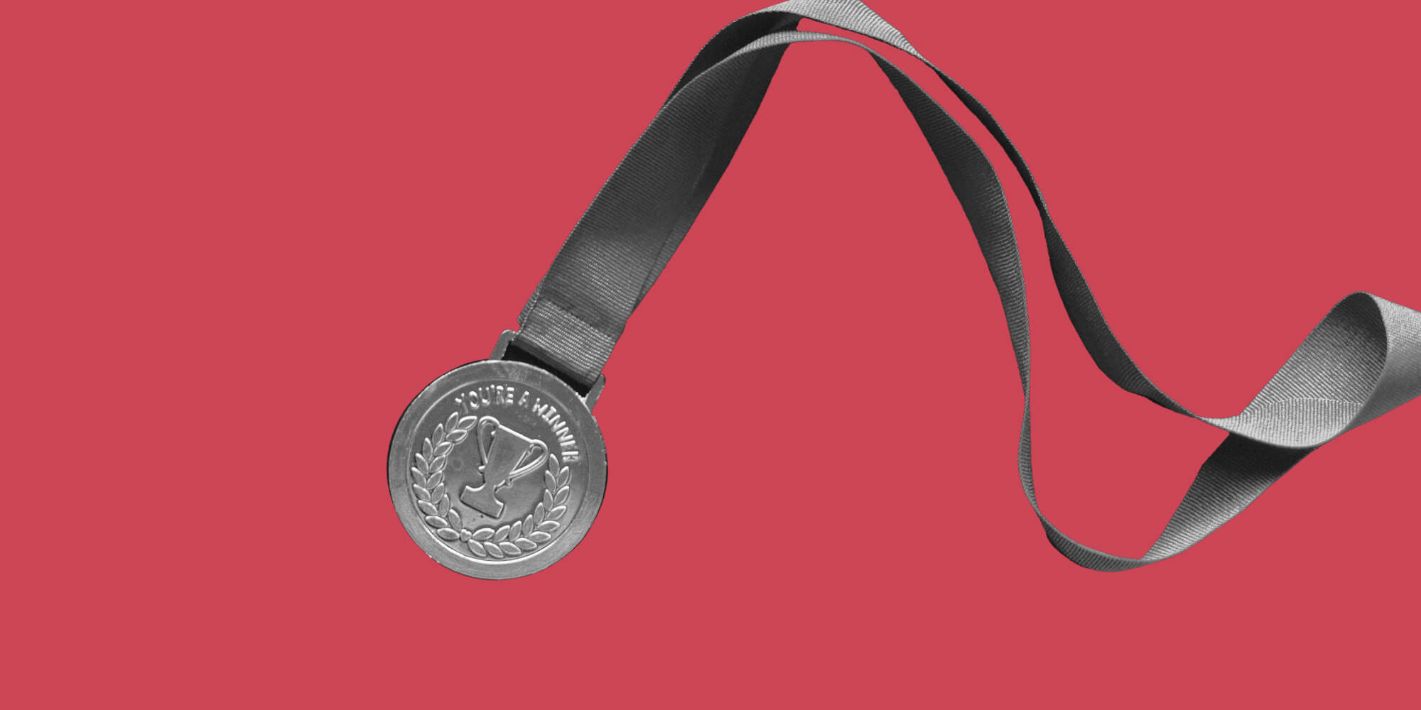A gold medal on a red background. Achieving a new level of sobriety