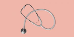 Stethoscope on peach background. Naltrexone side effects