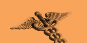 Rod of Asclepius on an orange background. Workit Health introduces a hepatitis C clinic