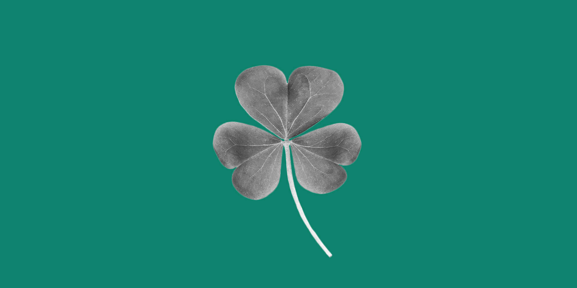 Shamrock on a green background. 7 reasons and alcohol-free St. Patrick's Day is lucky