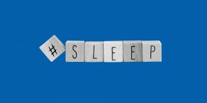 Wooden block spelling out #sleep. Sleeping in recovery