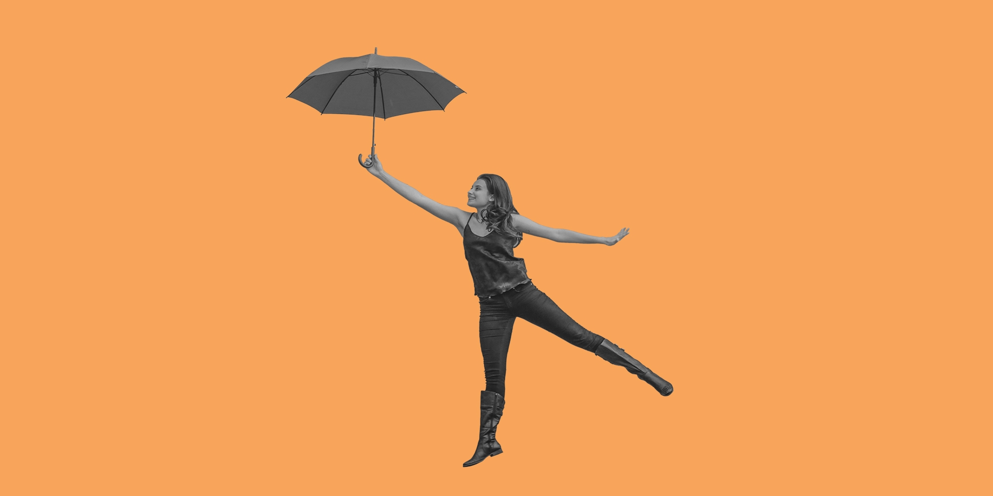 Woman with an umbrella, posed as though she's flying. Finding happiness after opioid addiction