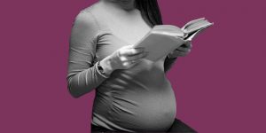 Pregnant woman reading a book. Medically-assisted treatment for opioids during pregnancy