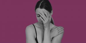 Self-medicating depression. Distressed woman with her hand over her face.