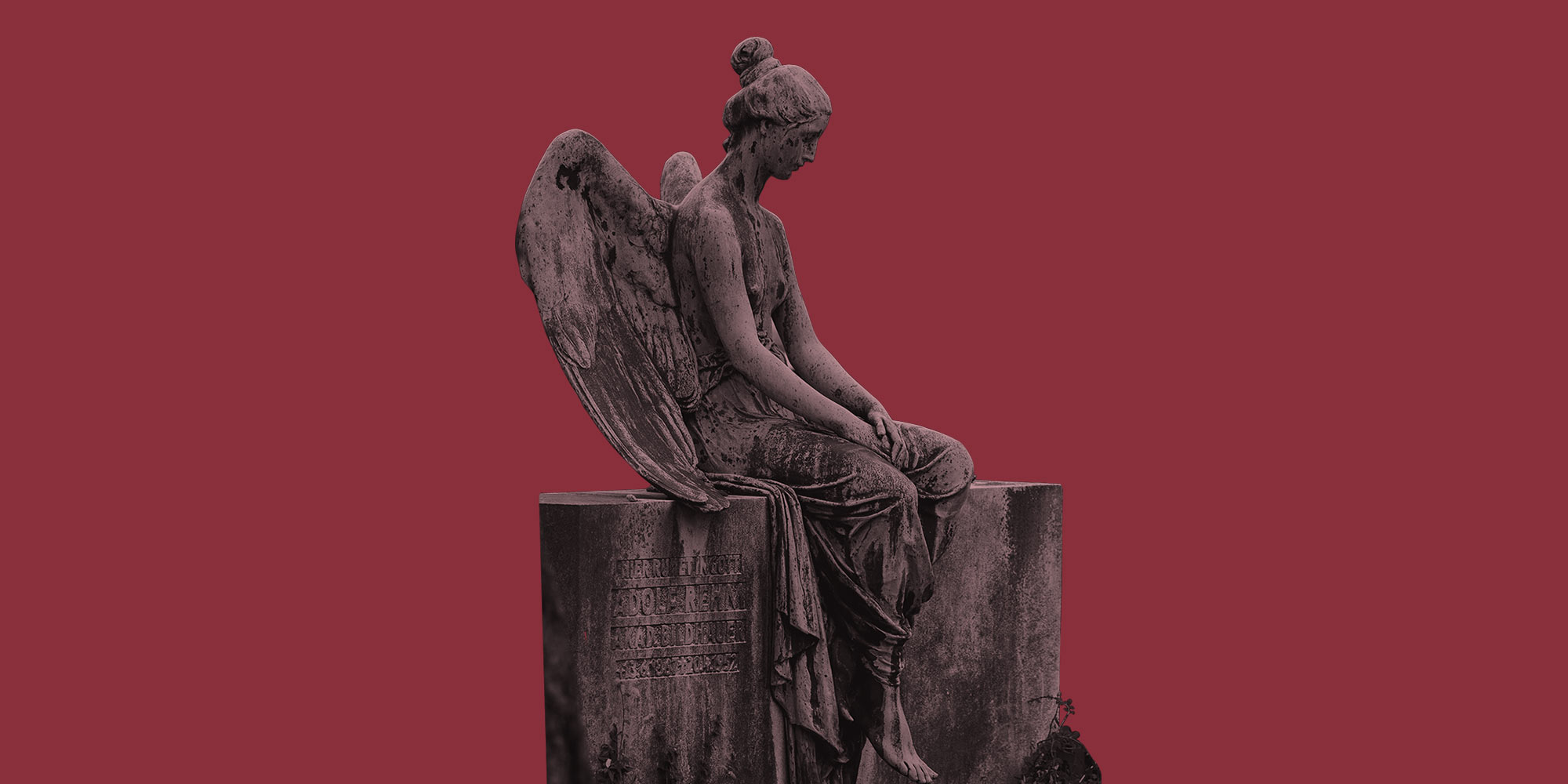 A stone angel statue in a cemetery. Grief and recovery