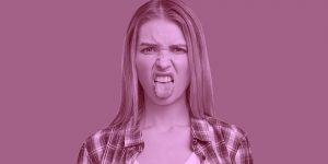 Woman making a disgusted face with her tongue sticking out. Suboxone tastes bad.