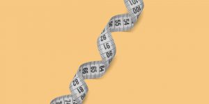 The long coil of a measuring tape across a yellow background. Applying Anti-Diet Practices in Recovery