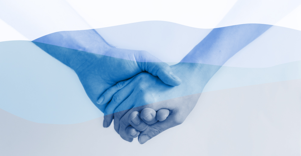 The clasped hands of two people with a wavy overlay of transparent blues. Why choose Blue Cross Blue Shield for addiction treatment