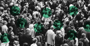 Black & white photo of a crowd of people with green dots over several individuals. Recovery is different for everyone.