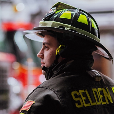 Male professional firefighter in gear and on the job