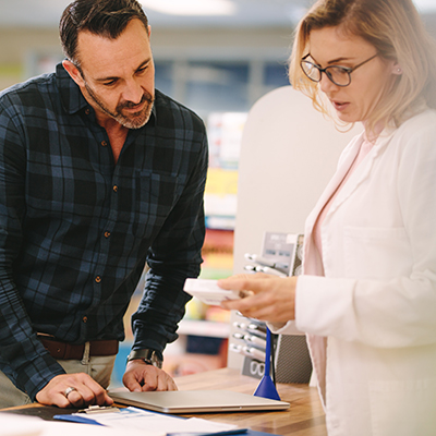 Man picking up a prescription at a pharmacy for recovery