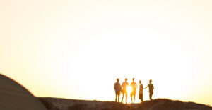 Silhouettes of a group against the setting sun. When I knew I was an alcoholic.