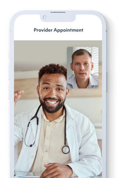 An iPhone displaying a 1:1 provider appointment. A Black male doctor wearing a labcoat and stethoscope is speaking with a White male member via video conferencing.