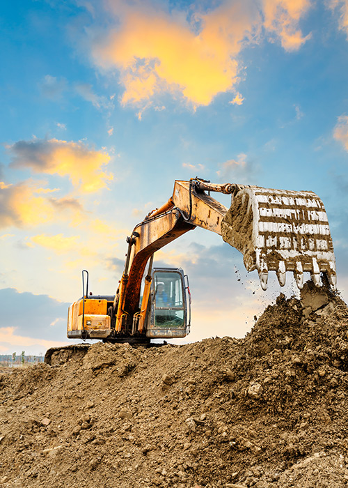 Backhoe scooping dirt - Construction