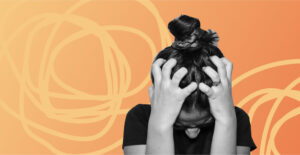 A woman clutching her head in distress against a orange and yellow background. Anxiety attack