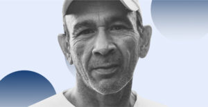 Older man in a baseball cap against a blue background. Recovery after 50