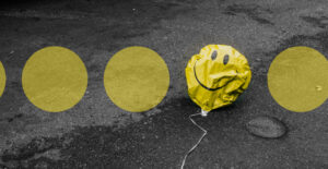 a row of yellow dots on pavement. One of them is replaced with a deflated, yellow smiley face balloon.Stigma Around Antidepressants Kept Me Trapped