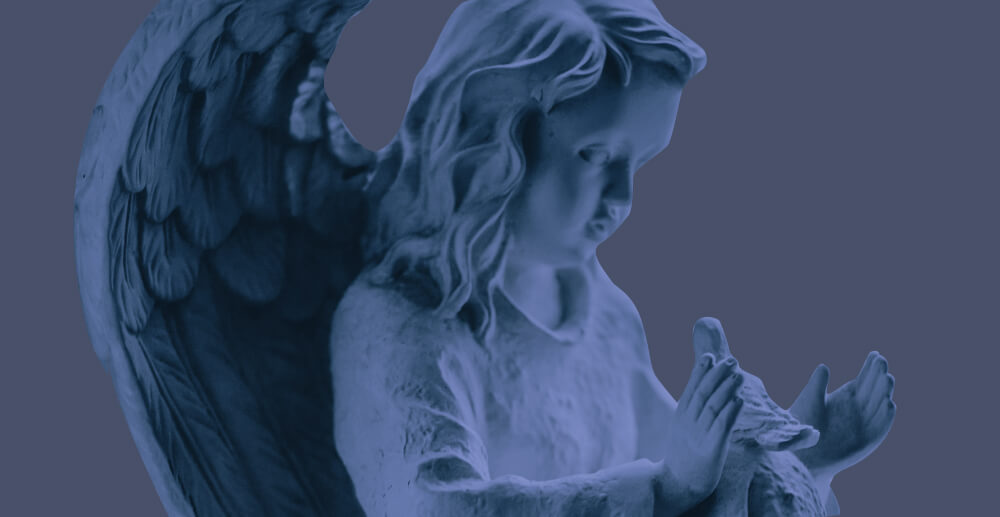 Statue of a sweet, childish angel holding a dove. Grieving