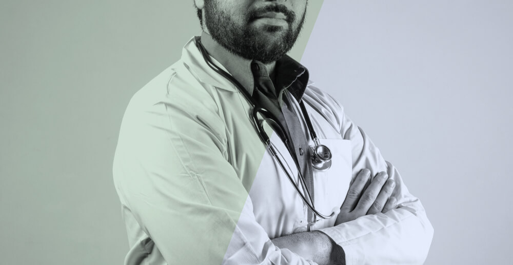 Male doctor in a lab coat with a stethoscope around his neck. Switching to a new Suboxone doctor