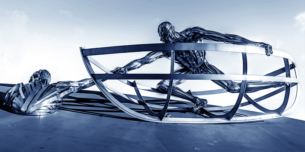 Metal sculpture of a person in a boat lifting another person from the water. Addiction recovery is life or death