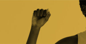 The fist of a Black person, held up in the gesture for power or solidarity. Black Recovery Leaders