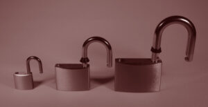 Three padlocks in graduated sizes, their hasps in the unlocked position. Smart, sober, and getting scammed.