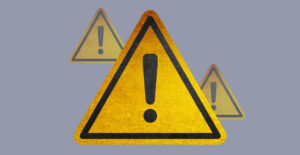 Yellow caution signs on a gray background. Alcohol Awareness Month.