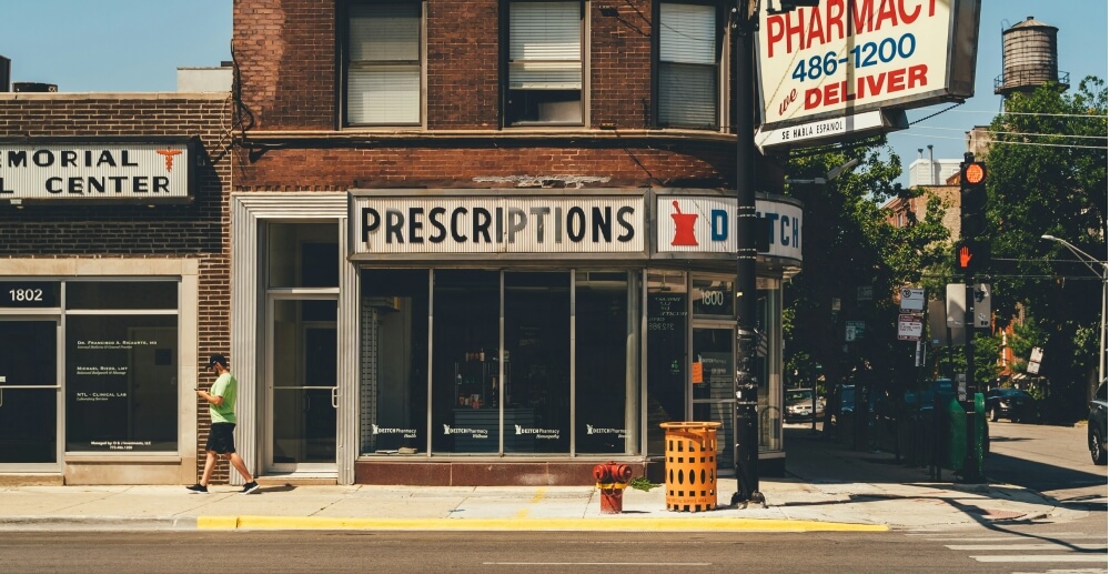 An old-fashioned pharmacy on a small town street.
