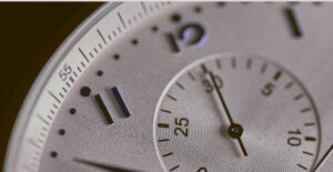 Closeup on a watch face showing the second hand.