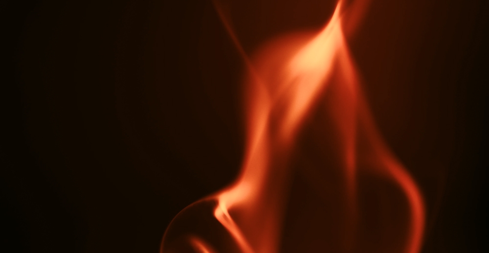 Closeup on a flame against a dark background