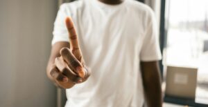 A Black man wags one finger in correction.