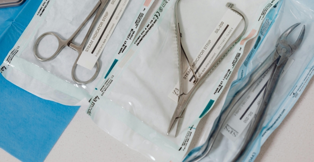 A tray of sterilized surgical tools, still in their wrapping.