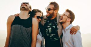 A group of four friends laugh together.