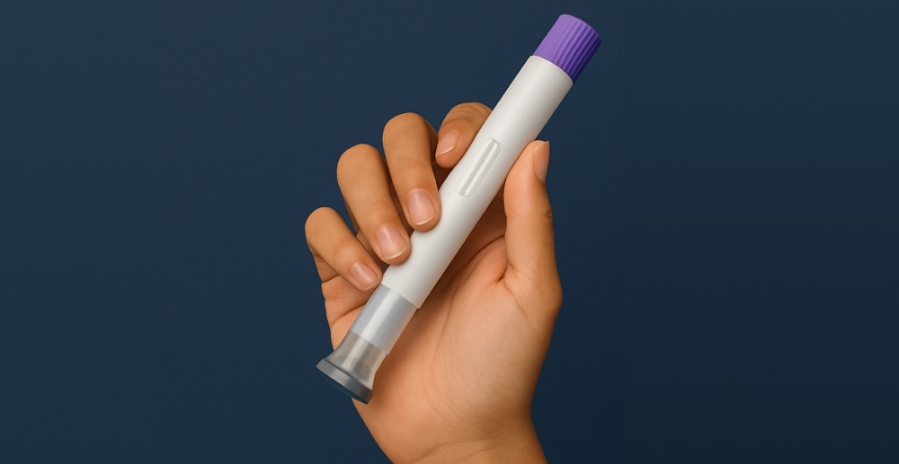 Hand holding a medication injector pen