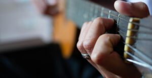 Closeup on a guiat being played